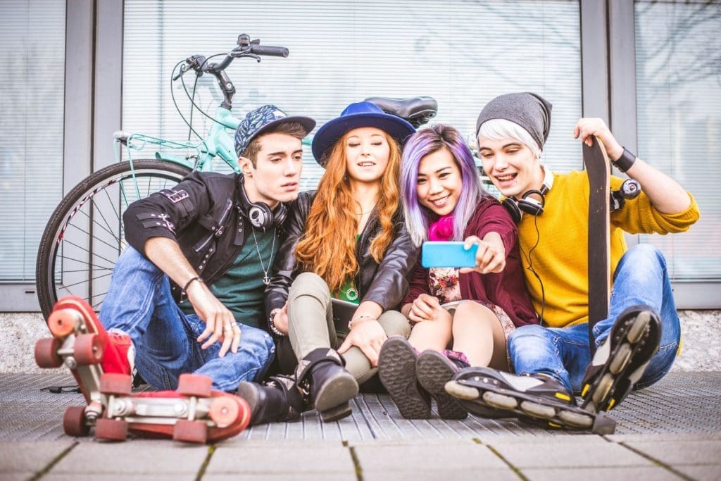 Group of teens enjoying the benefits of social media.