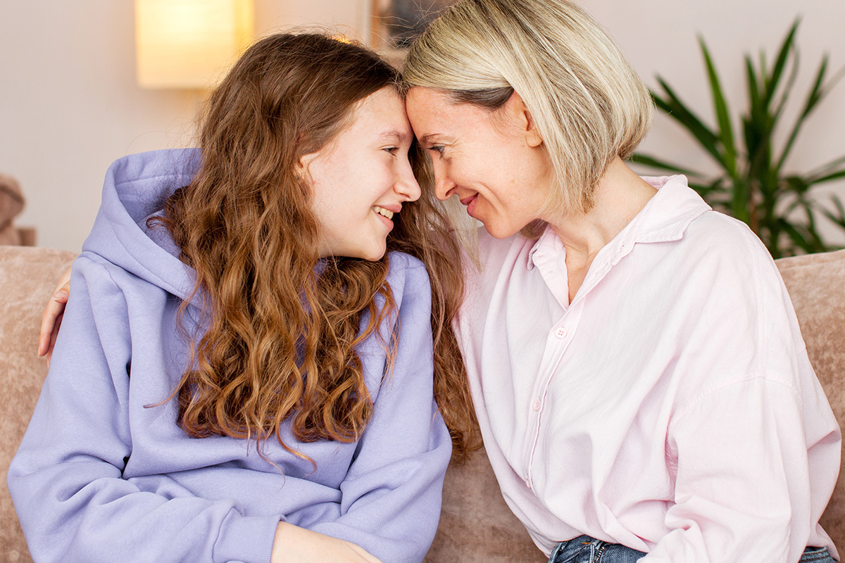 Adolescent daughter and mother in a healthy therapeutic relationship after treatment at Embark Behavioral health.